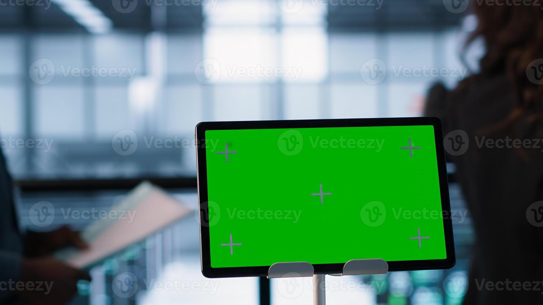 Focus on chroma key device in front of technicians analyzing metrics. Close up of isolated screen tablet next to server hub workers ensuring seamless operations, camera A photo