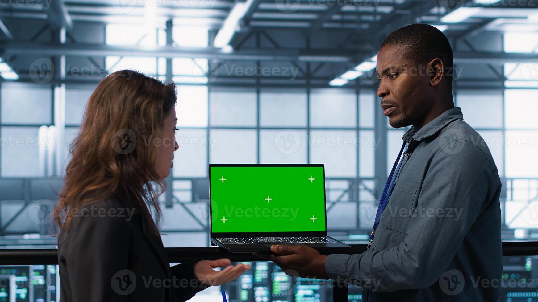 Technicians in data center using green screen laptop to develop disaster recovery plans. IT specialists in server farm testing failover scenarios on chroma key device, protecting data, camera A photo
