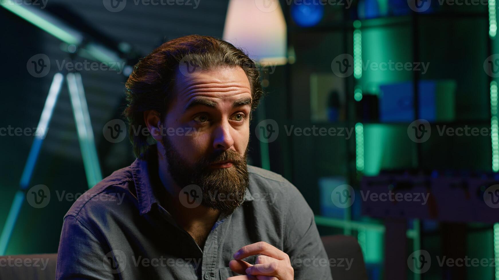 Man with surprised expression watching intriguing shows on TV and eating popcorn. Person paying close attention to screen, watching suspenseful thriller film, camera A close up photo