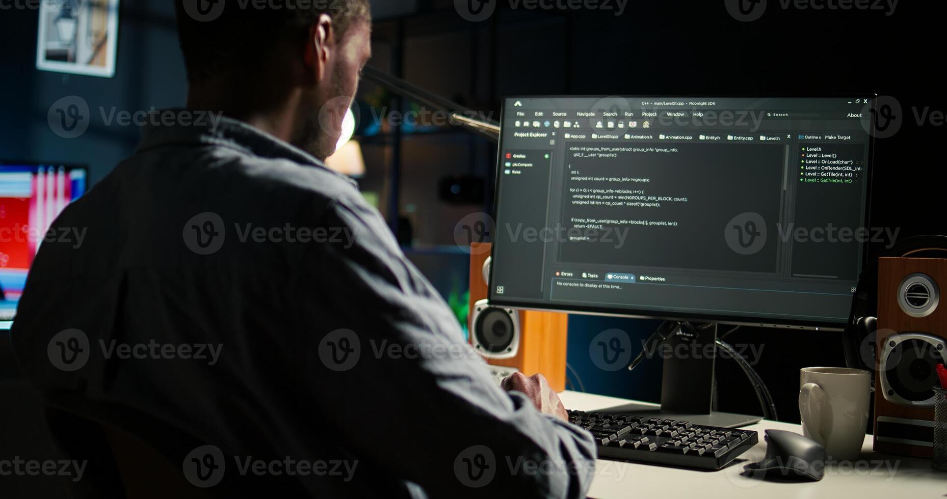 Black programmer manages code and scripts in artificial intelligence and machine learning on dual monitors computer setup. Male freelancer uses pc to guarantee cyber security. Camera A. photo