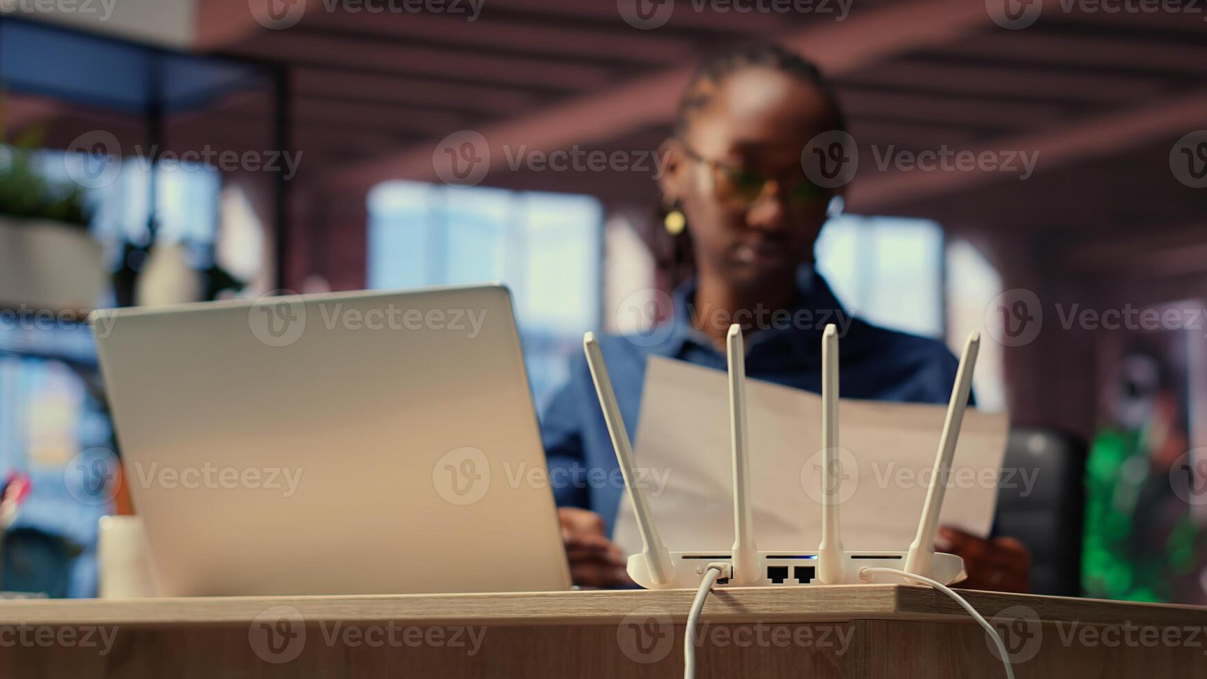 Young woman struggling with weak internet connection at home, pulling out LAN cable and adjusting Wi Fi settings to restore signal. Female freelancer with technical issues. Camera B. photo