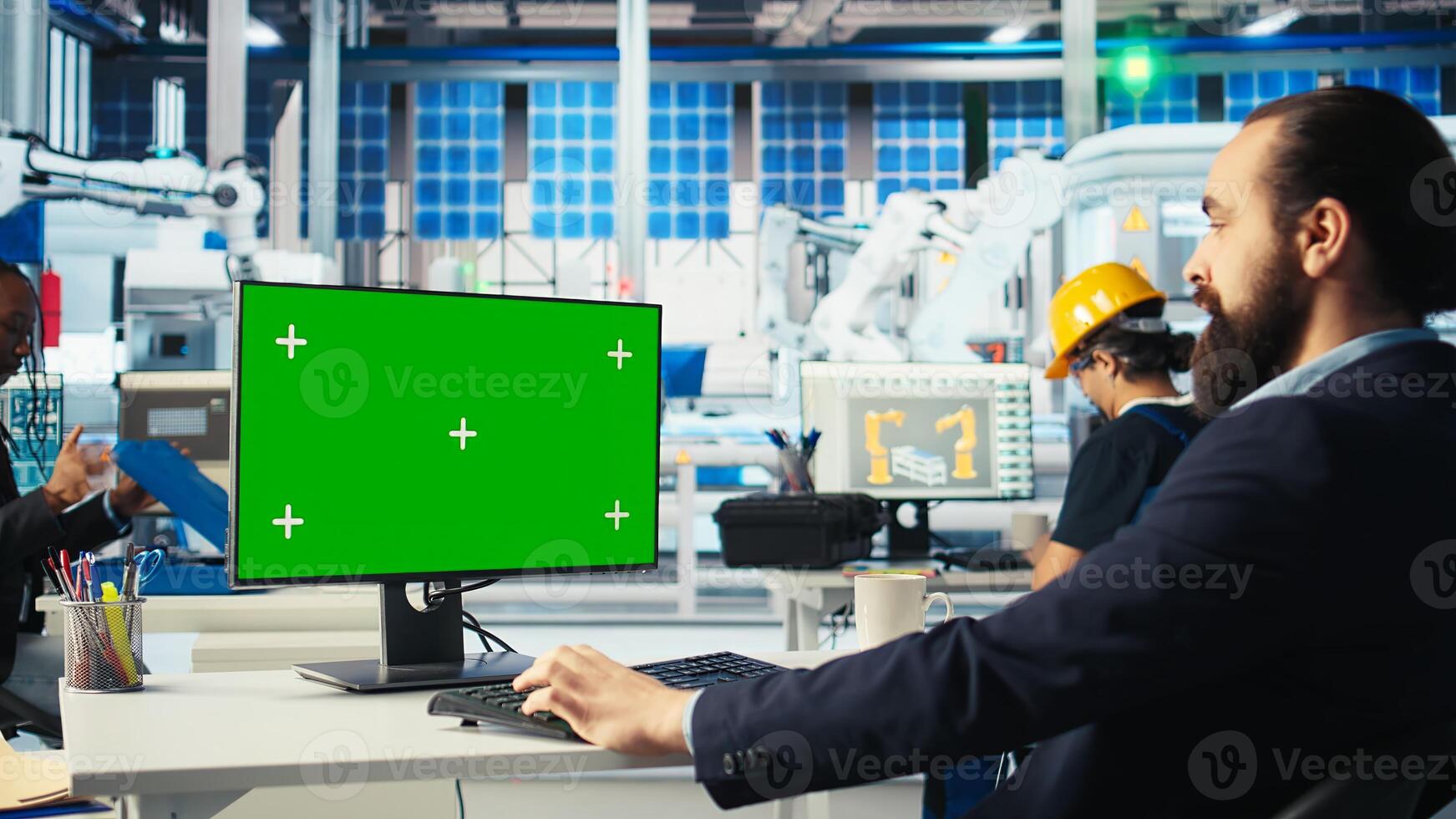 Engineer in photovoltaics factory using chroma key computer to diagnose malfunctioning systems. Solar manufacturing plant worker reducing downtime using green screen PC, camera A photo