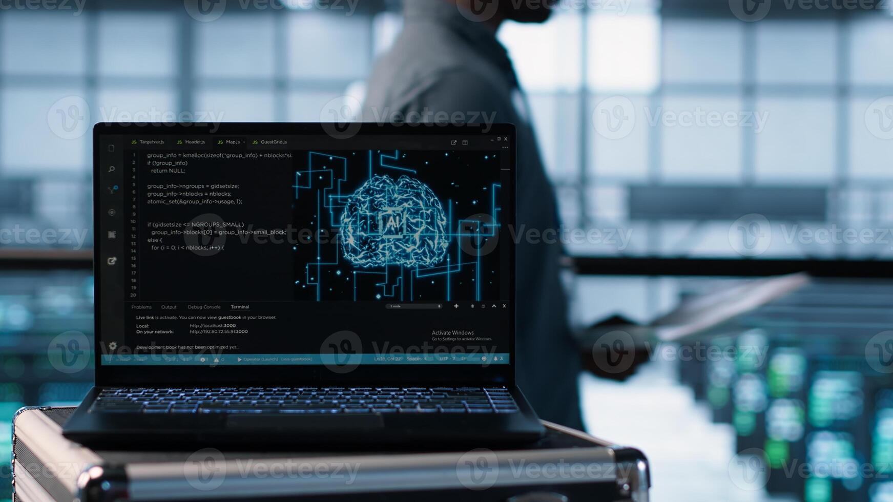 Artificial intelligence coding on laptop in data center with programmers in background employing machine learning models. Notebook used by AI experts, camera A close up photo