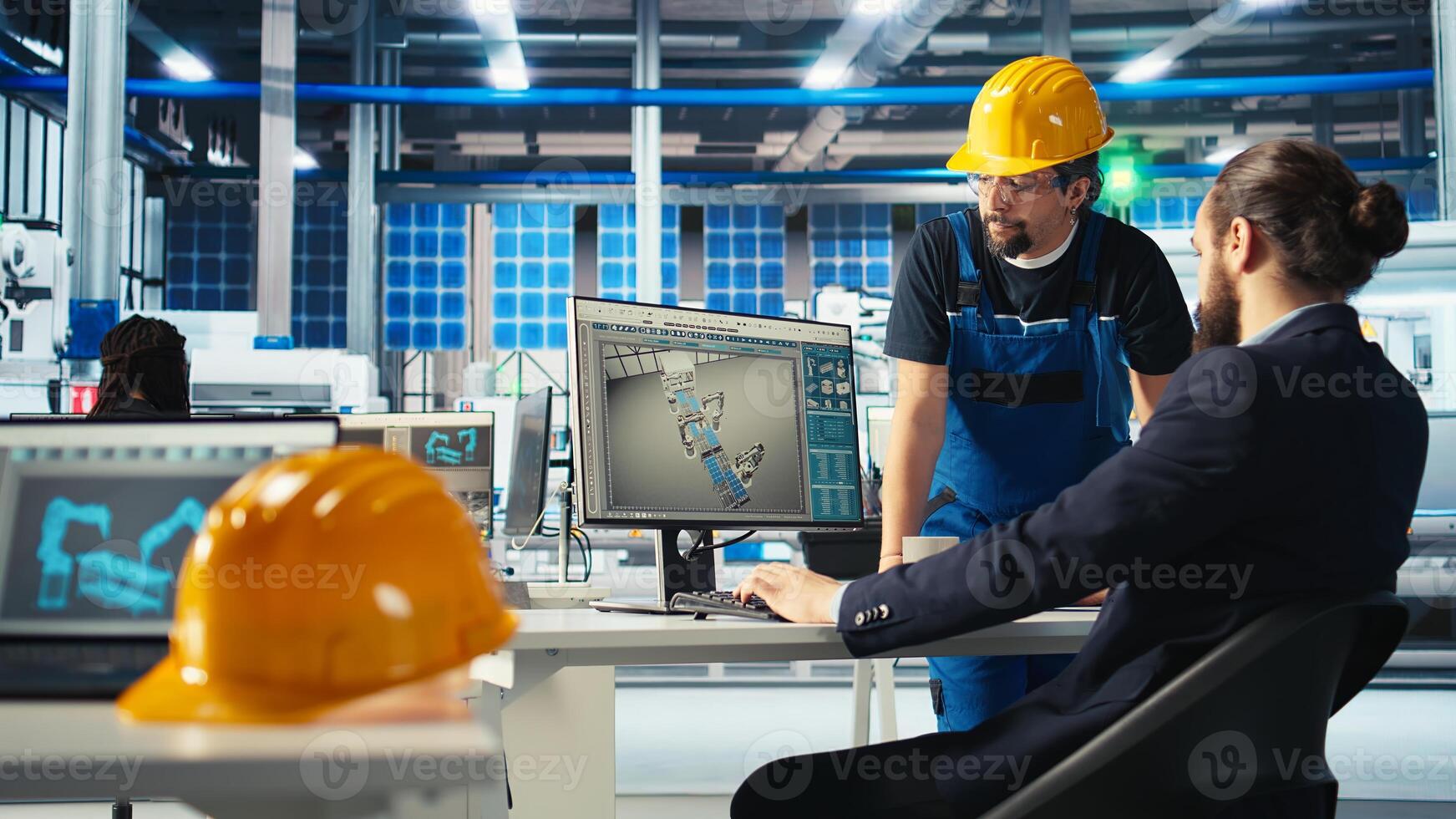 Photovoltaics factory manager showing engineer how to adjust system parameters. Specialist guiding staff member how to optimize energy supply in solar panel manufacturing plant, camera A photo