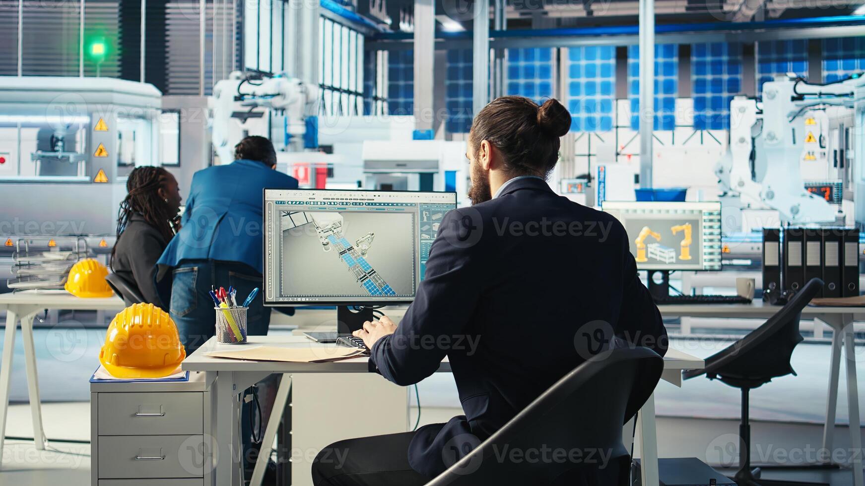 Photovoltaics expert looking over specifications on documents to ensure robot arms placing solar panels on assembly lines are running optimal. Specialist reads solar plant machinery paperwork photo
