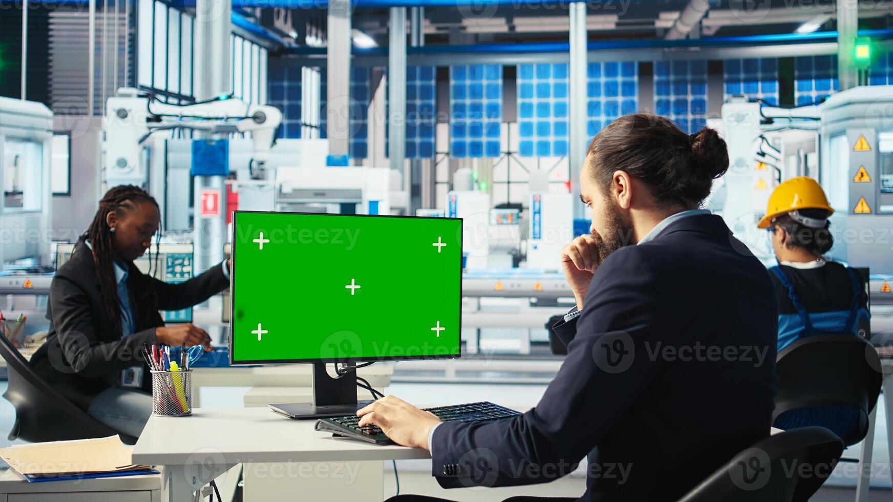 Photovoltaics factory worker analyzing data on green screen PC, reviewing system metrics. Smart manufacturing plant employee troubleshooting technical issues using chroma key computer, camera A photo
