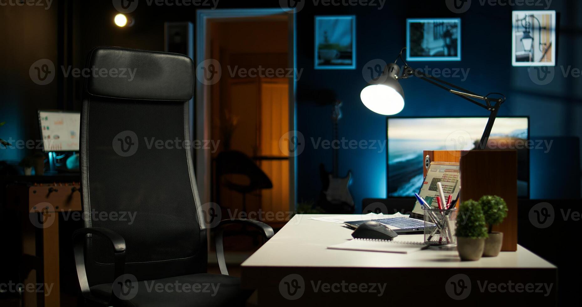 Contemporary loft style apartment with homey office corner. Wooden floors, decorative plants and TV creating stylish comfortable and creative urban space for work and relaxation. photo