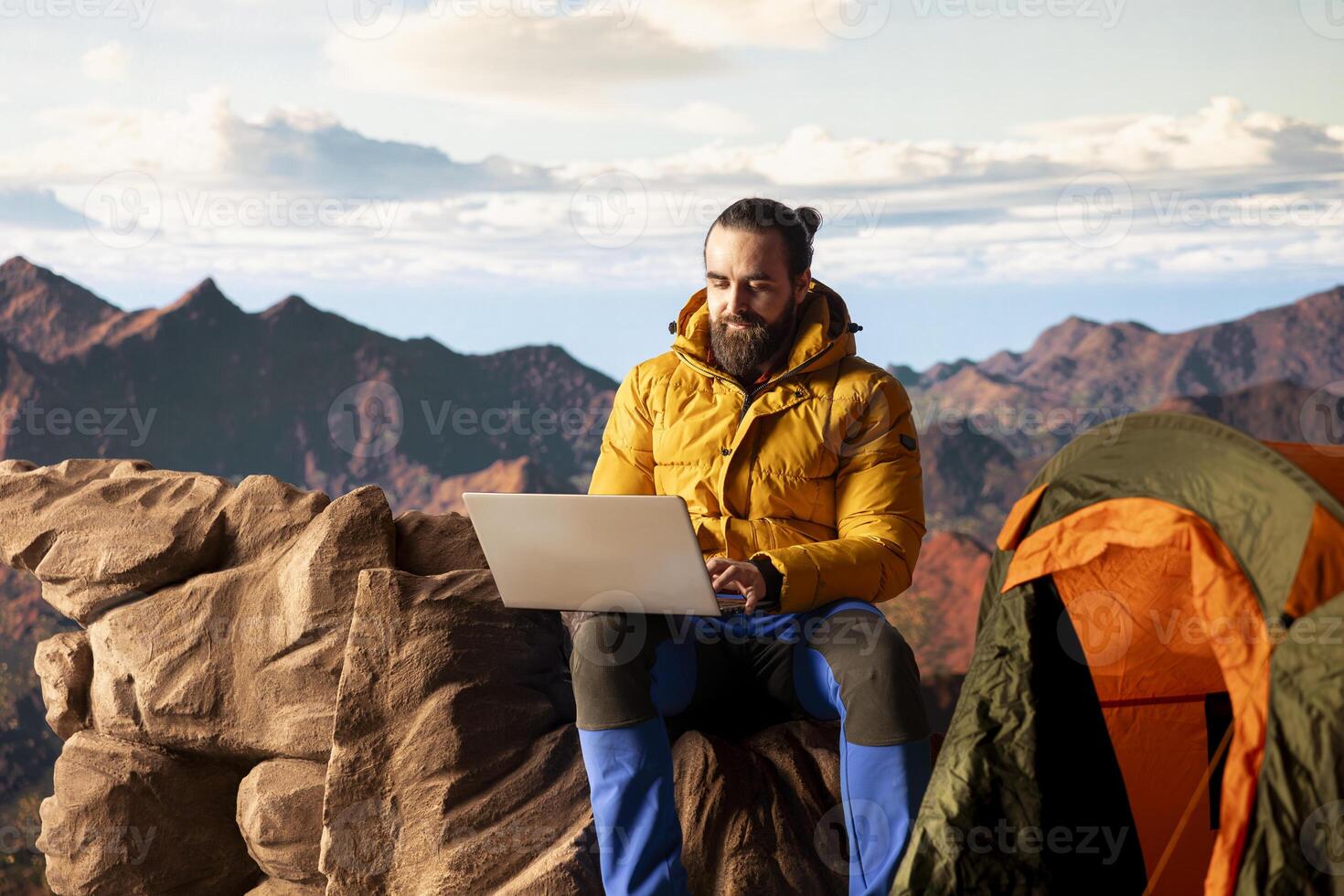 Nature lover workaholic always connected to internet and scrolling on laptop, enjoying web strong signal on mountain top with breathtaking landscape. Uninterrupted work. photo
