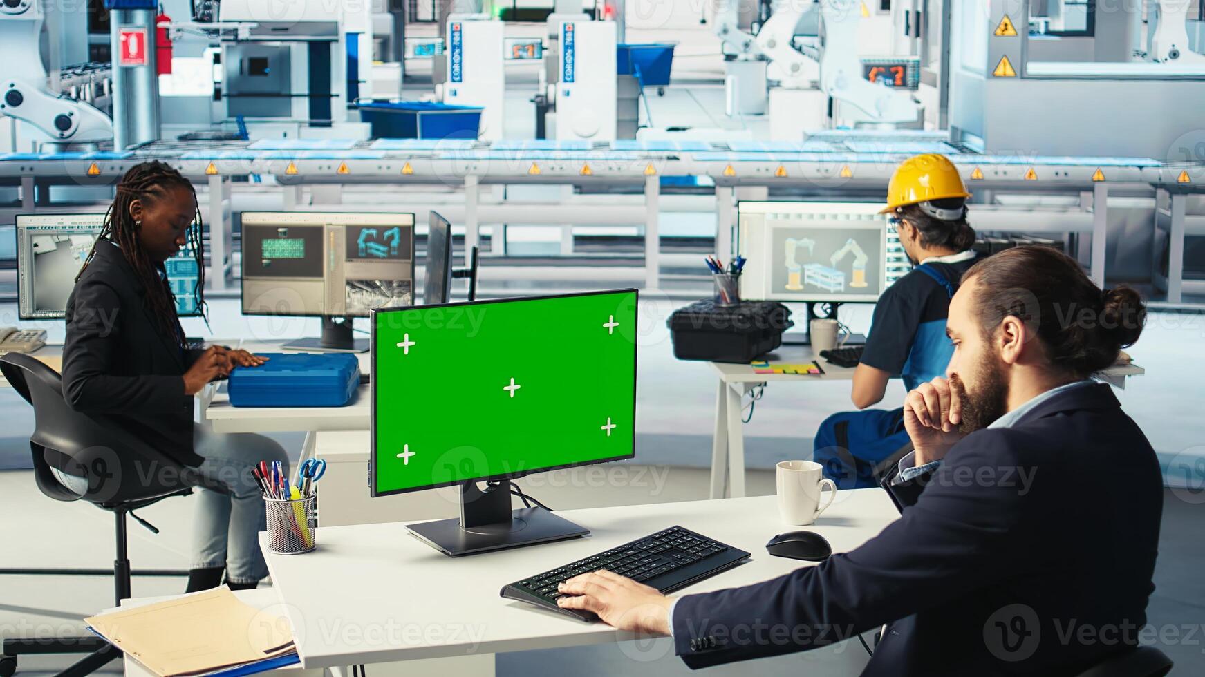 Factory worker monitors system performance on green screen PC. Solar panels manufacturing plant employee using chroma key computer to track energy production and efficiency, camera A photo