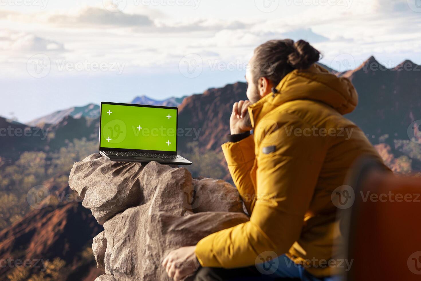 Traveler embraces high altitude wilderness next to chroma key, using device where crisp air and scenic mountain view provide inspiring setting for trekking and adventure. photo