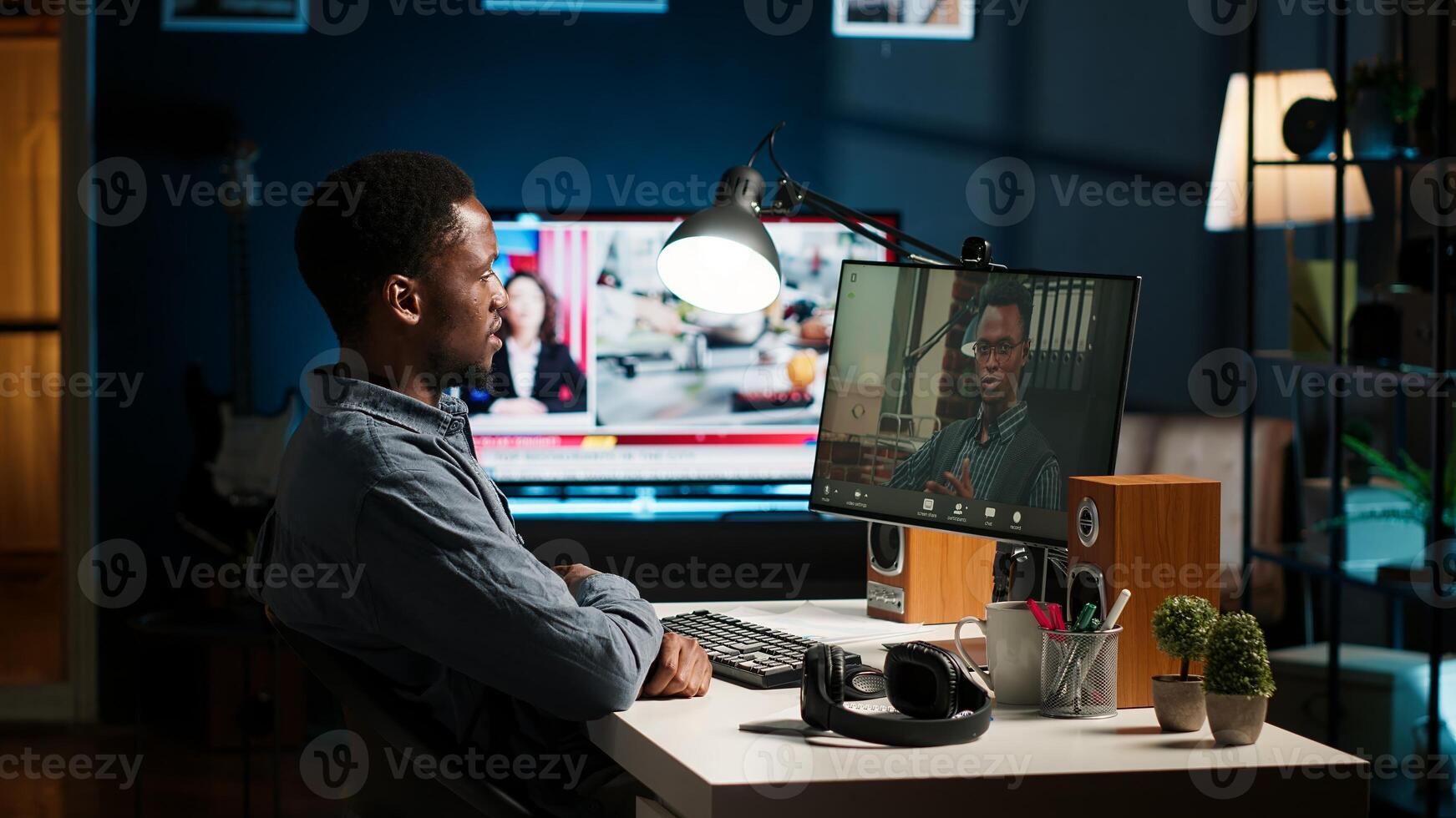 Black remote worker meeting with team leader via conference call, sharing ideas and insight on tasks from home office setup. Young adult joining web chat with boss. Camera B. photo