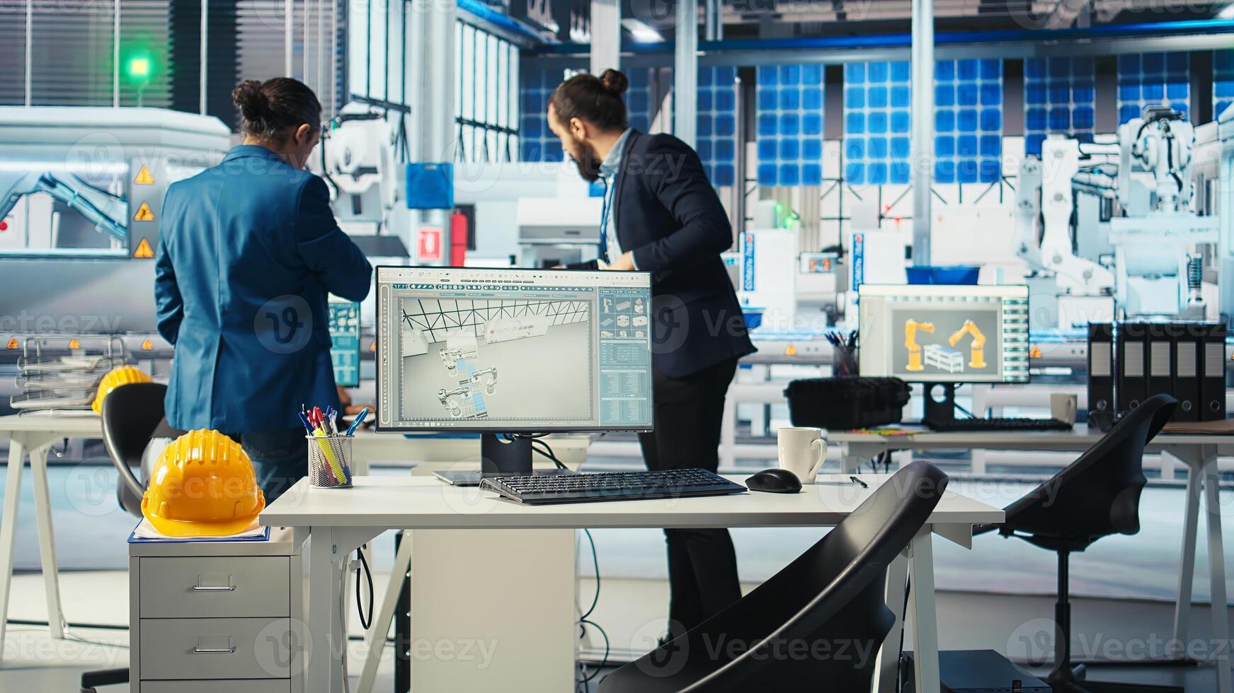 Photovoltaics factory manager working with solar engineering team to improve new system design and reliability. Smart manufacturing plant inspector providing feedback to employees photo