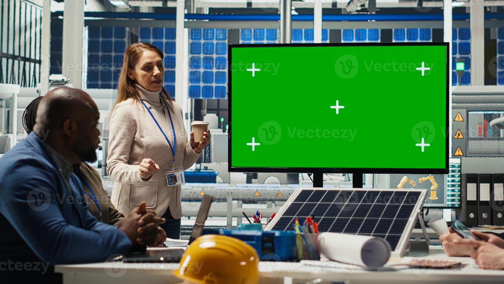 Photovoltaics researchers doing meeting, looking at chroma key monitor, evaluating energy production. Experts optimize factory gear energy output, looking at isolated screen display, camera B photo