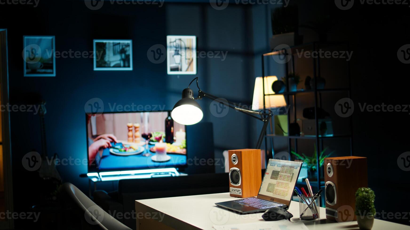 Home office in stylish apartment with wooden furniture and cozy decorations, urban loft. House plants, smart TV and creative workspace with desk setup for a comfortable lifestyle. photo