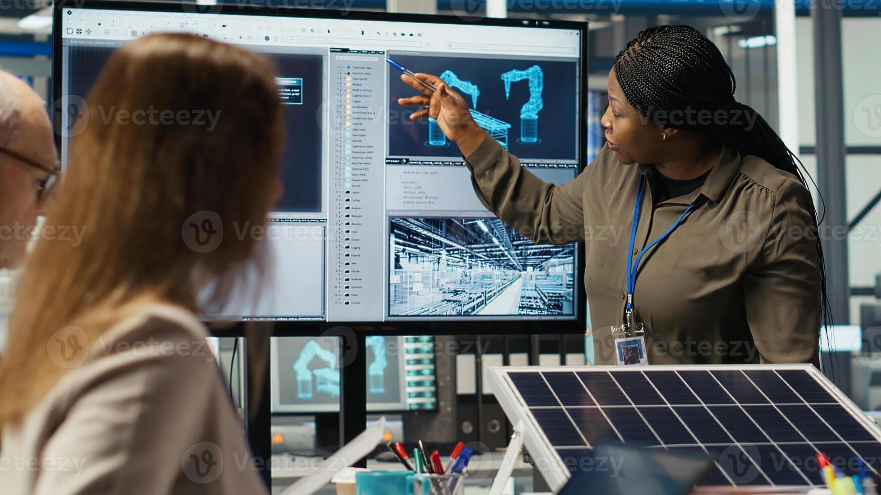 Engineering team in photovoltaics plant improving solar cells efficiency. Smart factory research and development department staff working on clean energy solutions, camera B photo