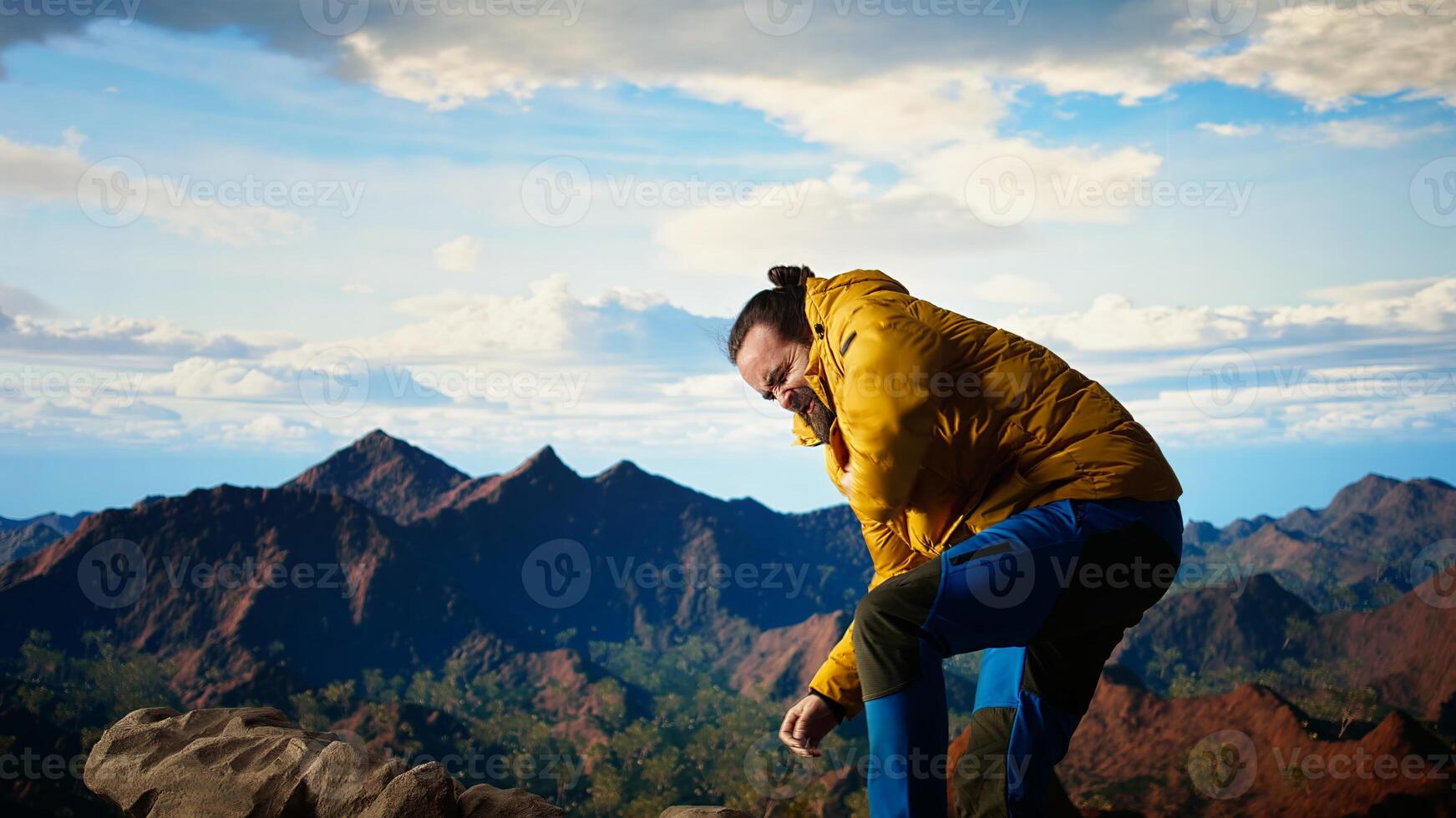 Reckless hiker stumbles near edge of high altitude cliff, caught off guard by strong winds. Unequipped for extreme conditions, losing balance on mountain top. Camera A. photo