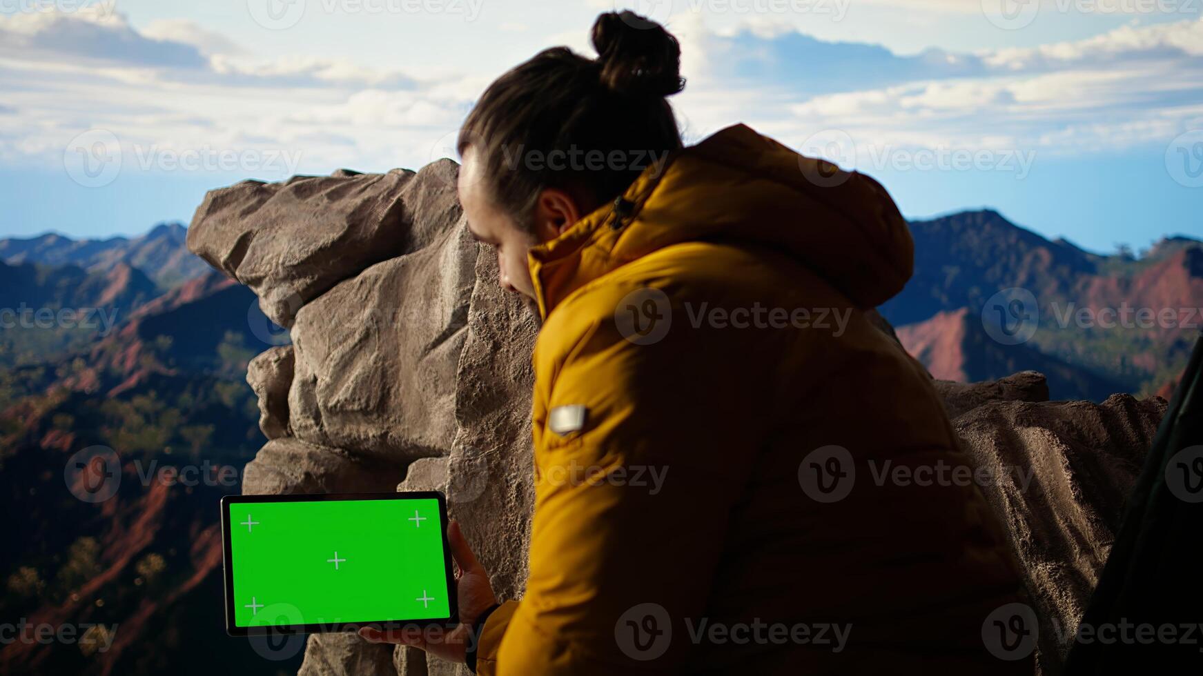 Adventure seeker standing at mountain peak next to isolated chroma key, looking at scenic view that stretches endlessly before him. Fresh air and breathtaking landscape. Camera A. photo
