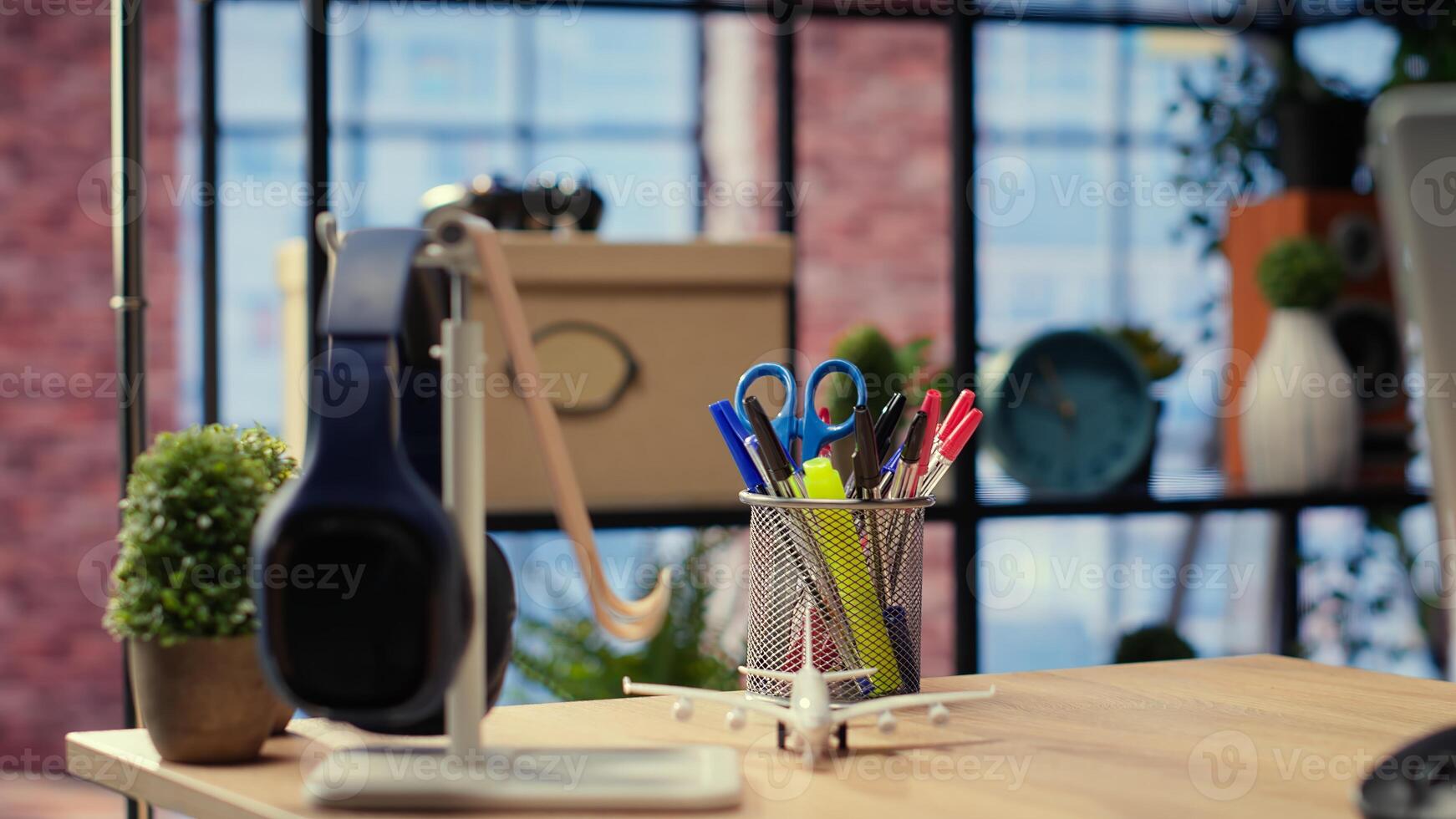 Spacious studio with clean layout and inviting homey vibe, home office with gadgets and supplies. Stylish furniture with contemporary and minimalist interior, wooden floors. photo