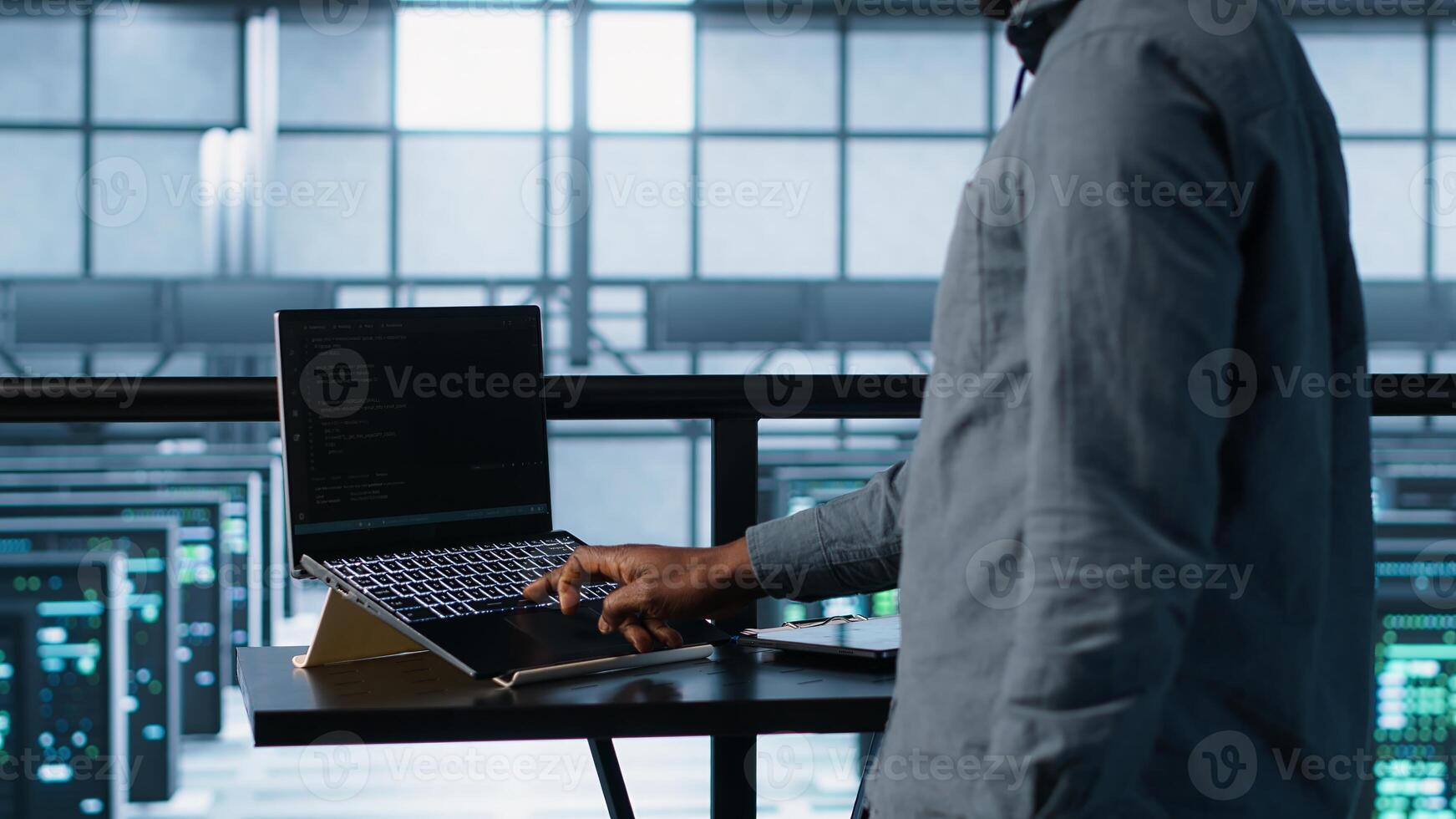 Technician in data center using AI on laptop and tablet, developing disaster recovery plans. Server farm employee using artificial intelligence tech on devices, testing scenarios, camera A photo