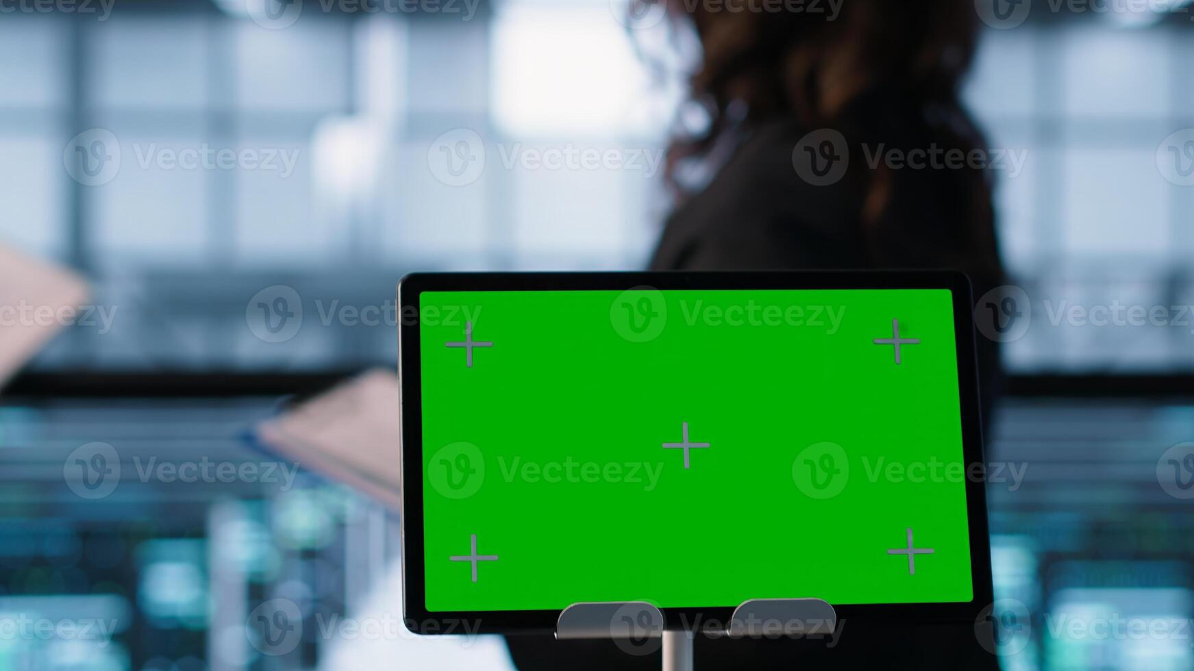 Close up of chroma key tablet next to data scientists conducting security audits, preventing bugs. Green screen device and man working with colleague in data center, camera A photo