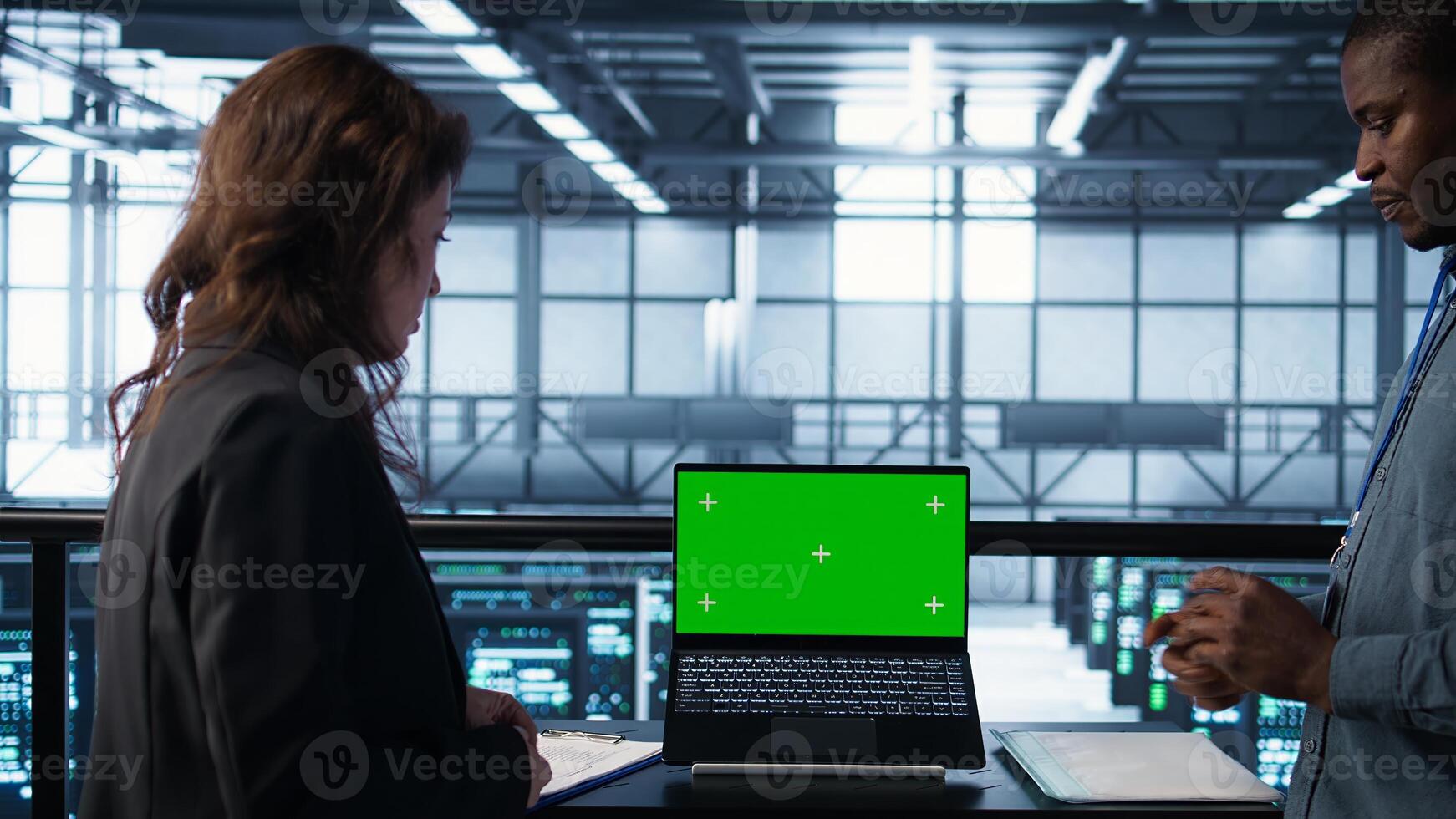 Coworkers using mockup laptop, integrating green technologies. IT experts in server room using chroma key notebook to implement sustainable energy solutions, camera B close up photo