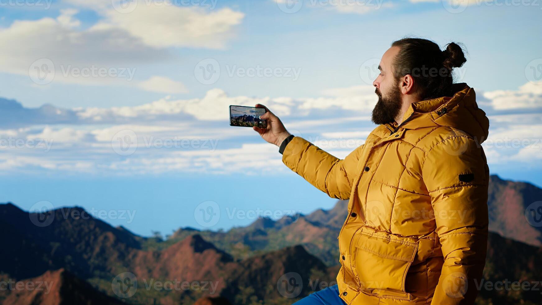 Hiker capturing breathtaking scenic view at top of mountain, gazing at distantand embracing beauty of wilderness. Joy of discovering wonders. Camera B. photo