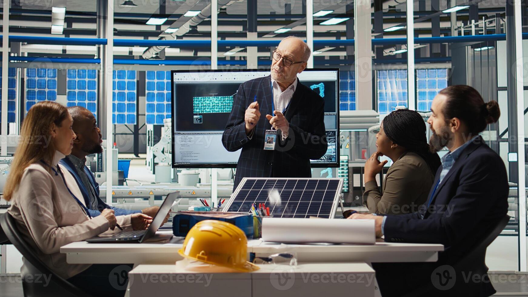 Businessmen in photovoltaics factory doing financial investments in sustainable manufacturing sector. Executives meet to discuss automation strategies for solar panel production, camera A photo