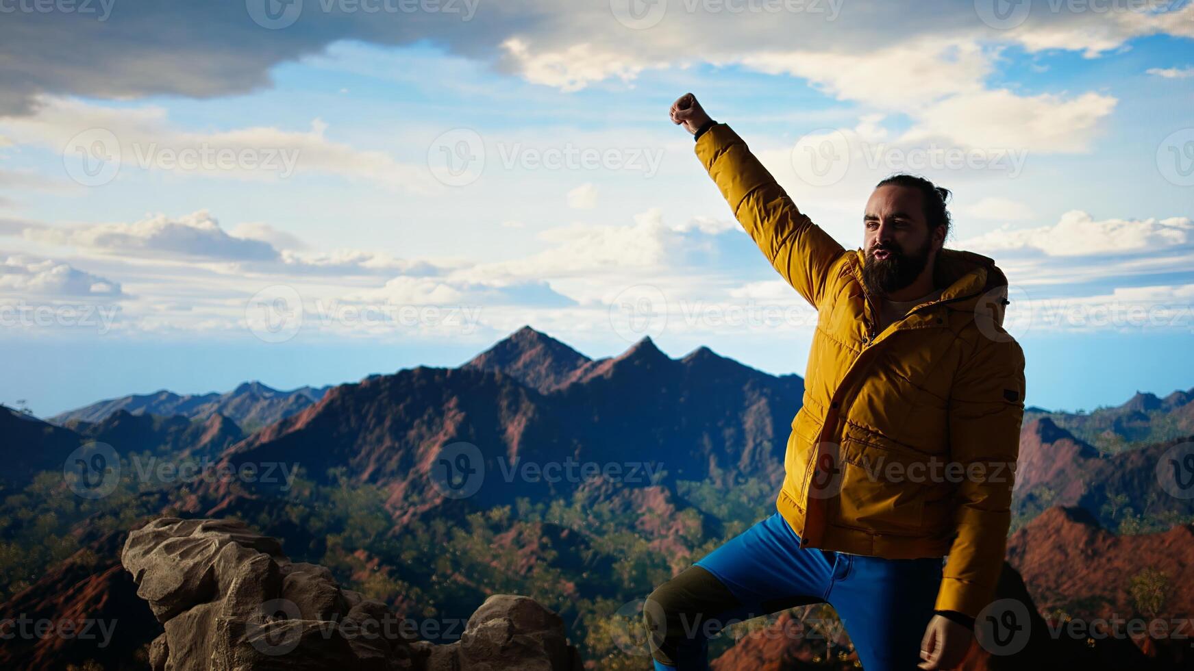 Hiker dressed in warm outdoor gear celebrates reaching top of mountain, stunning view and sense of satisfaction embodies thrill of adventure and personal strength. Camera A. photo