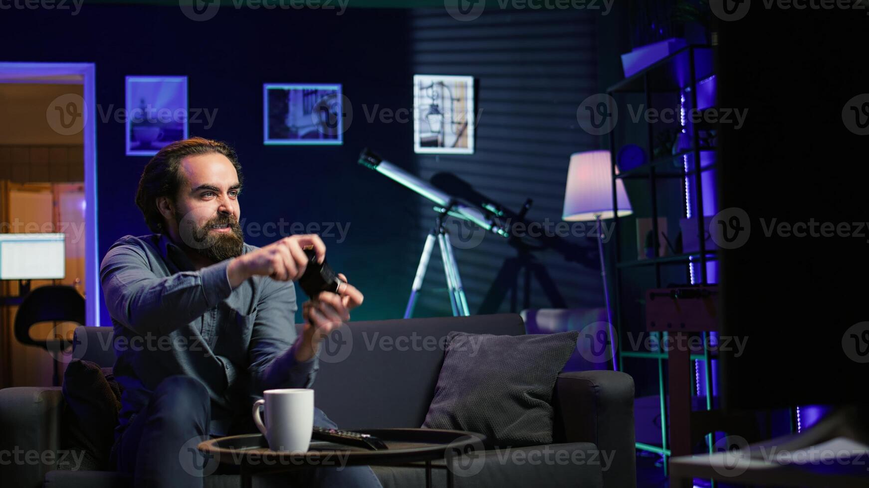 Gamer feeling gutted after losing videogame level, screaming at television in anger. Angry man at home yelling, frustrated after seeing game over screen on smart TV display photo