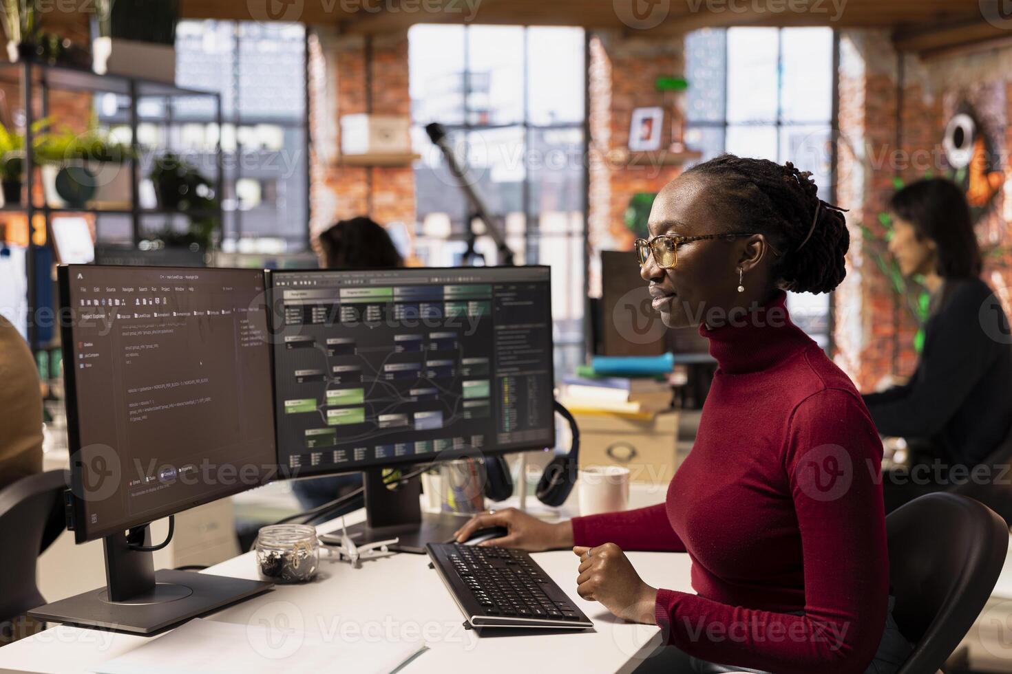 Computer scientist in startup office designing, coding and debugging applications in different software languages. African american woman doing code testing and quality assurance photo