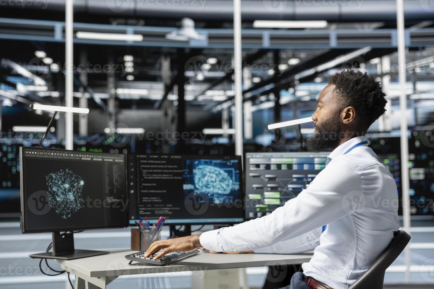 Data center engineer using machine learning algorithms on computer to analyze vast datasets to recognize emerging trends and predict future patterns based on historical data photo