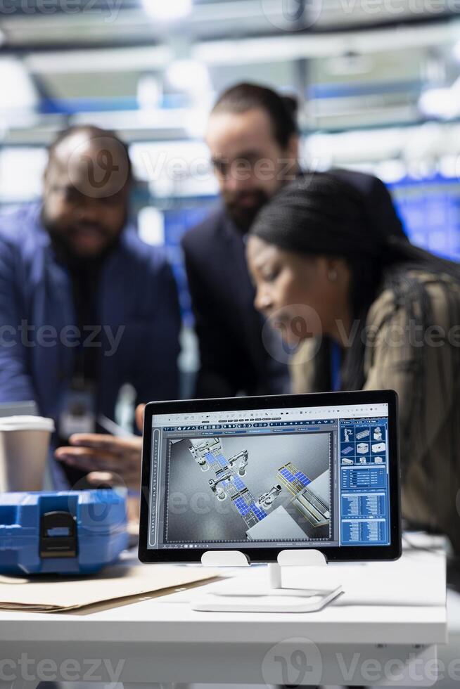 Diverse group of consultants engineers conducting inspection on solar panel performance, combining corporate oversight and quality control in a clean alternative energy factory. photo