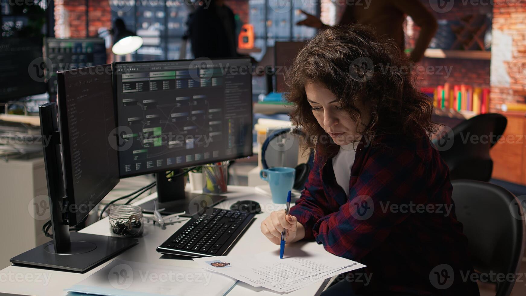 Tech startup HR employee analyzing candidates for job opening, reviewing resumes to determine skills. Woman screening people for software development Silicon Valley company position, camera A photo