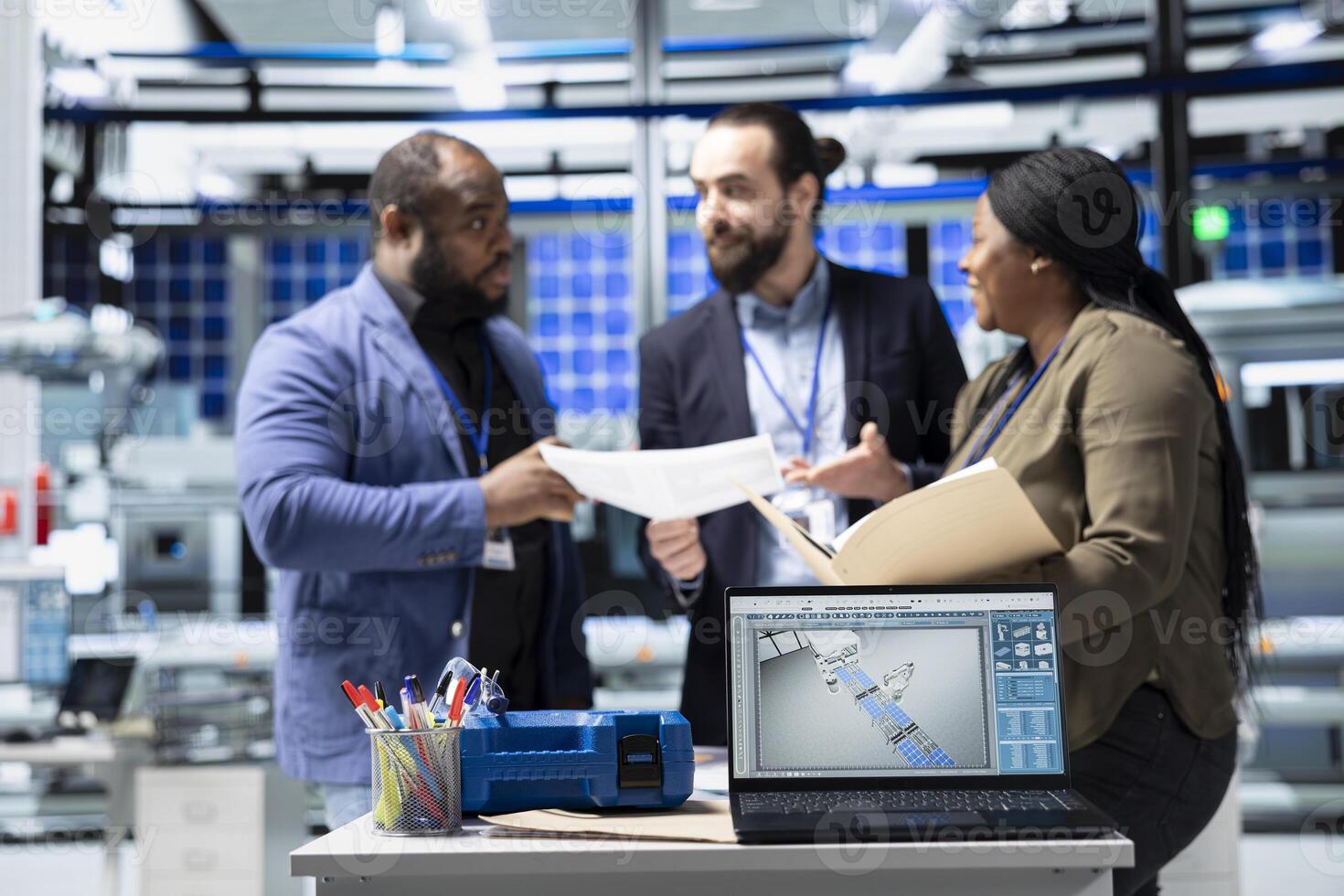Diverse master engineers group examining solar panels production line in a plant, ensuring a good manufacturing process and production with teamwork. Industrial renewable energy. photo