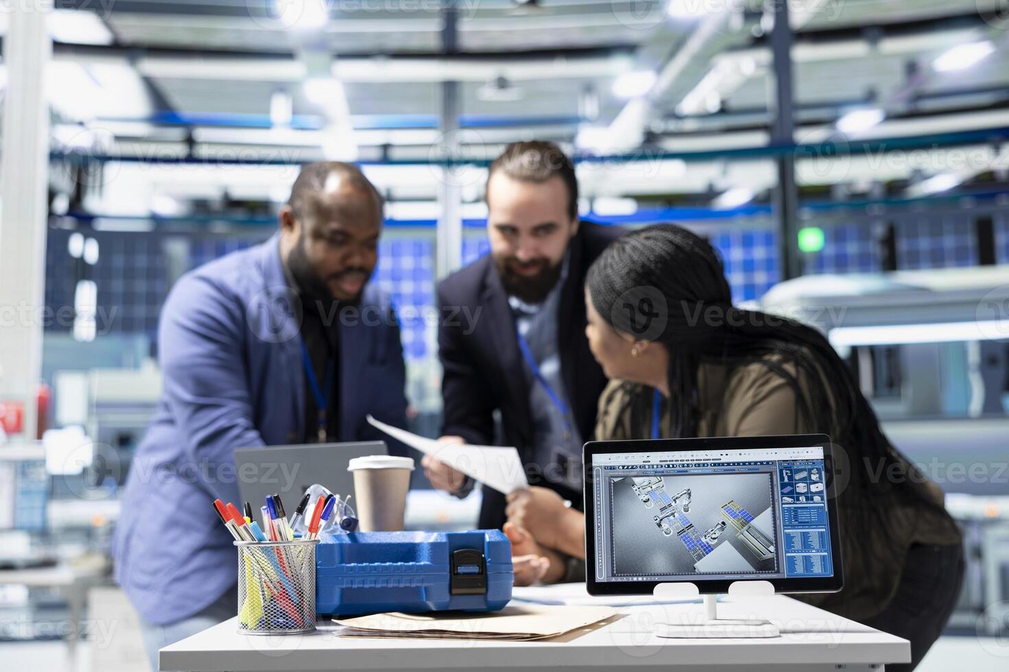 Factory supervisors diverse group engaging in briefing over production metrics, supporting industrial innovation and sustainable process improvement. Solar power manufacturing. photo