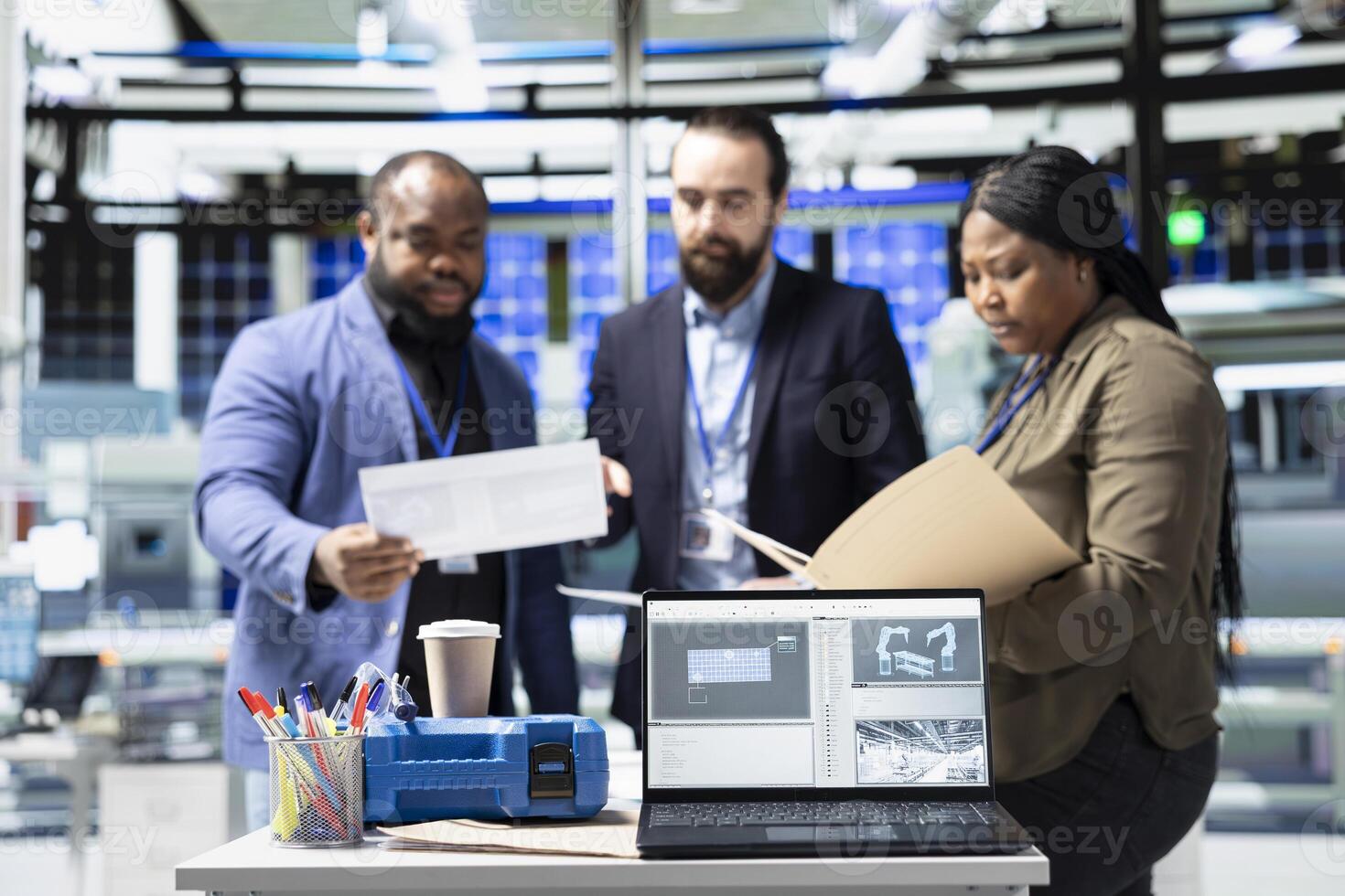 Diverse team of professional engineers and analysts discuss improvements in solar tech manufacturing process, advancing renewable energy through shared insight and industrial innovation. photo