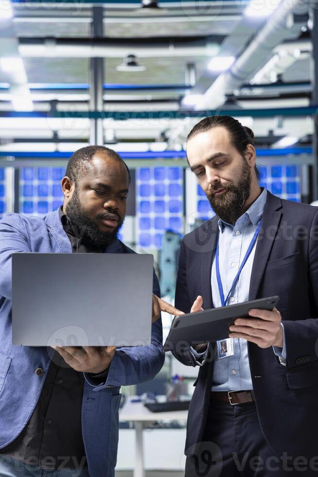 Multiethnic professional consultants engaging in a strategy meeting briefing on the production line, aligning corporate goals with renewable power engineering innovations. Photovoltaics. photo