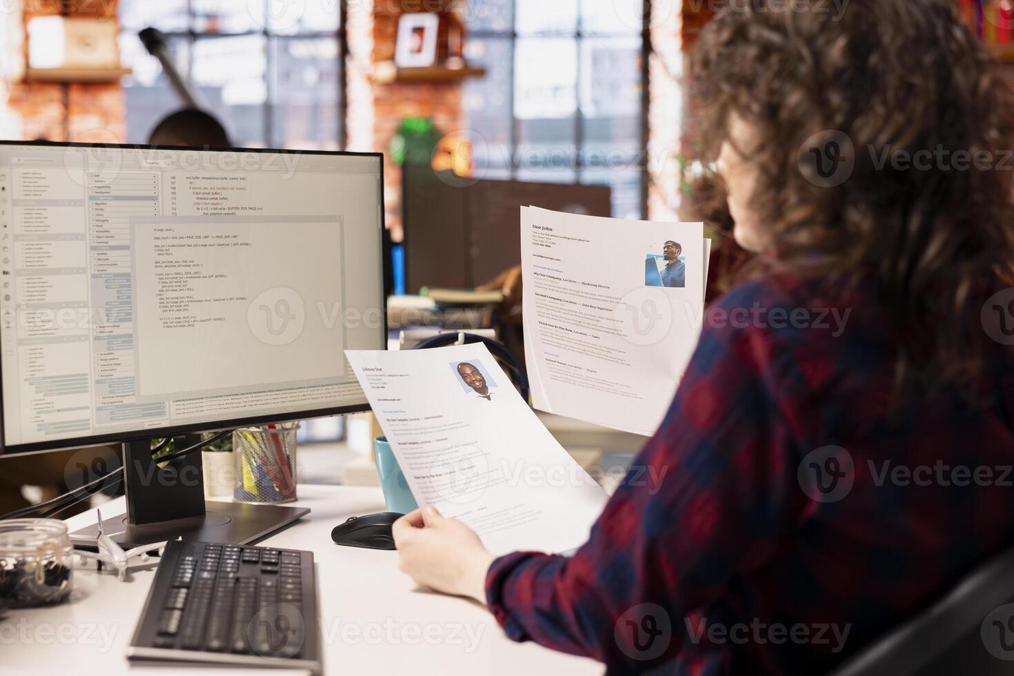 Startup HR worker identifying right candidates for job opening, reviewing resumes to determine qualifications. Woman doing screening process, selecting skilled people for software development position photo
