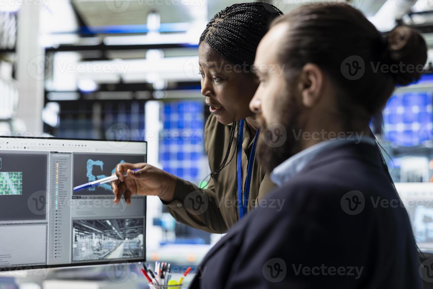 Diverse building contractors and associates checks solar power systems, during production line and manufacturing operations. Engineers doing teamwork to ensure sustainability goals. photo