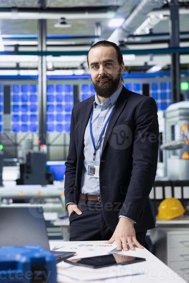 Manufacturing analyst reviewing solar panel production workflow, focusing on technological precision and sustainable power development in a high tech industrial environment. photo