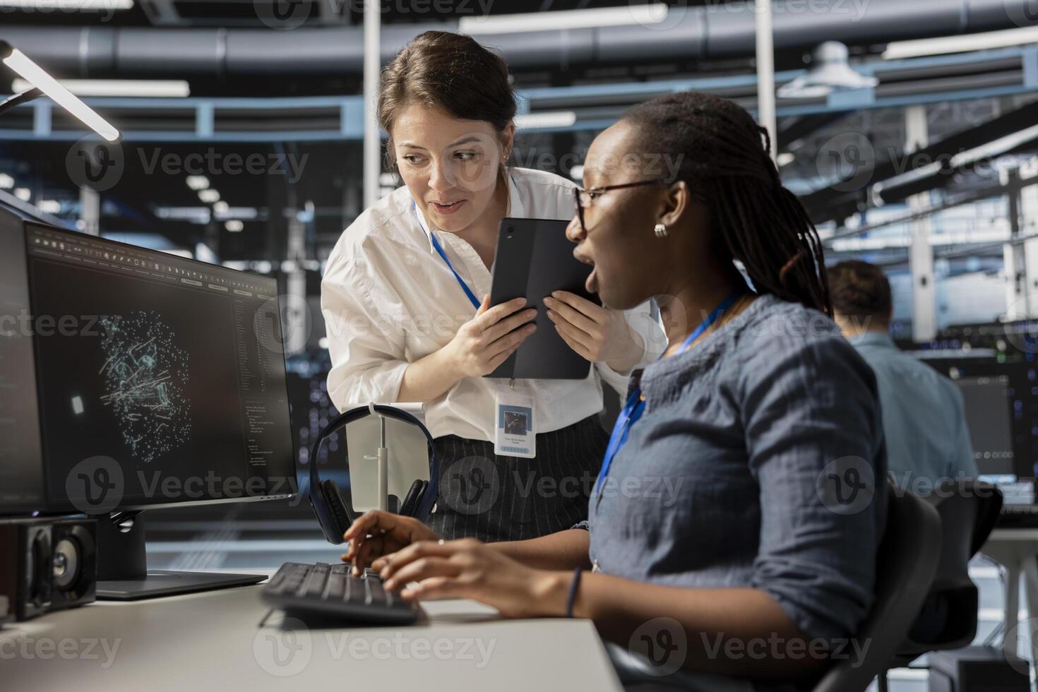 Data center technicians look at visualization on PC screen to pinpoint equipment performance issues. Server hub teamworking colleague look at data analysis graph to reduce hardware failures photo