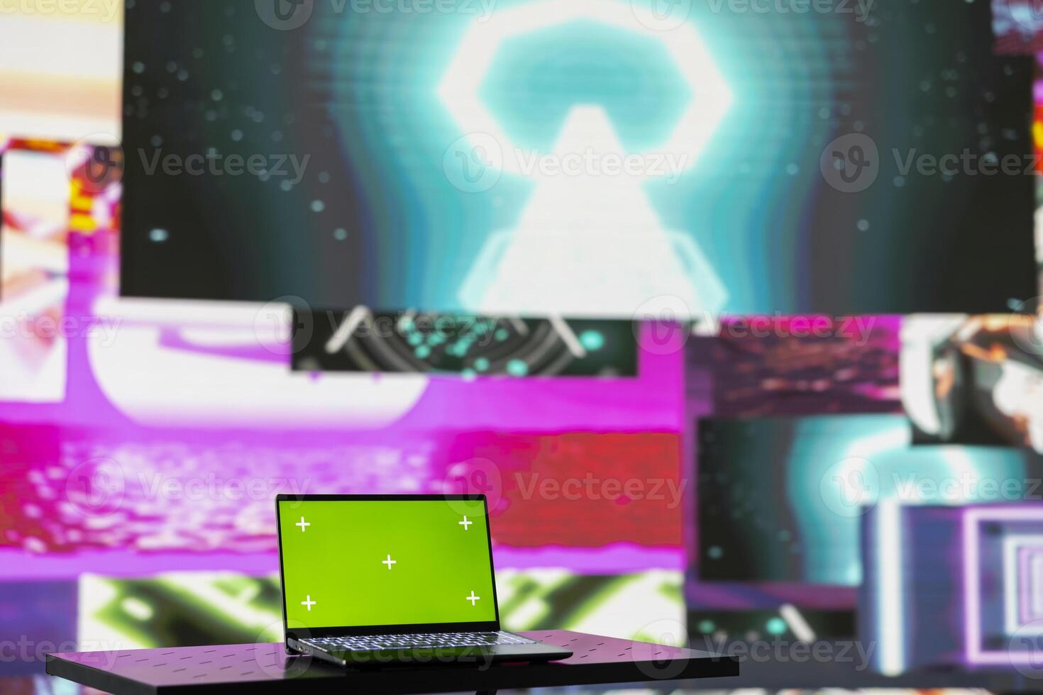 Laptop running isolated mockup screen surrounded by funky visual art clips, glowing in the dark and creating a clubbing atmosphere. Nightlife ambiance with modern beats and lights. photo
