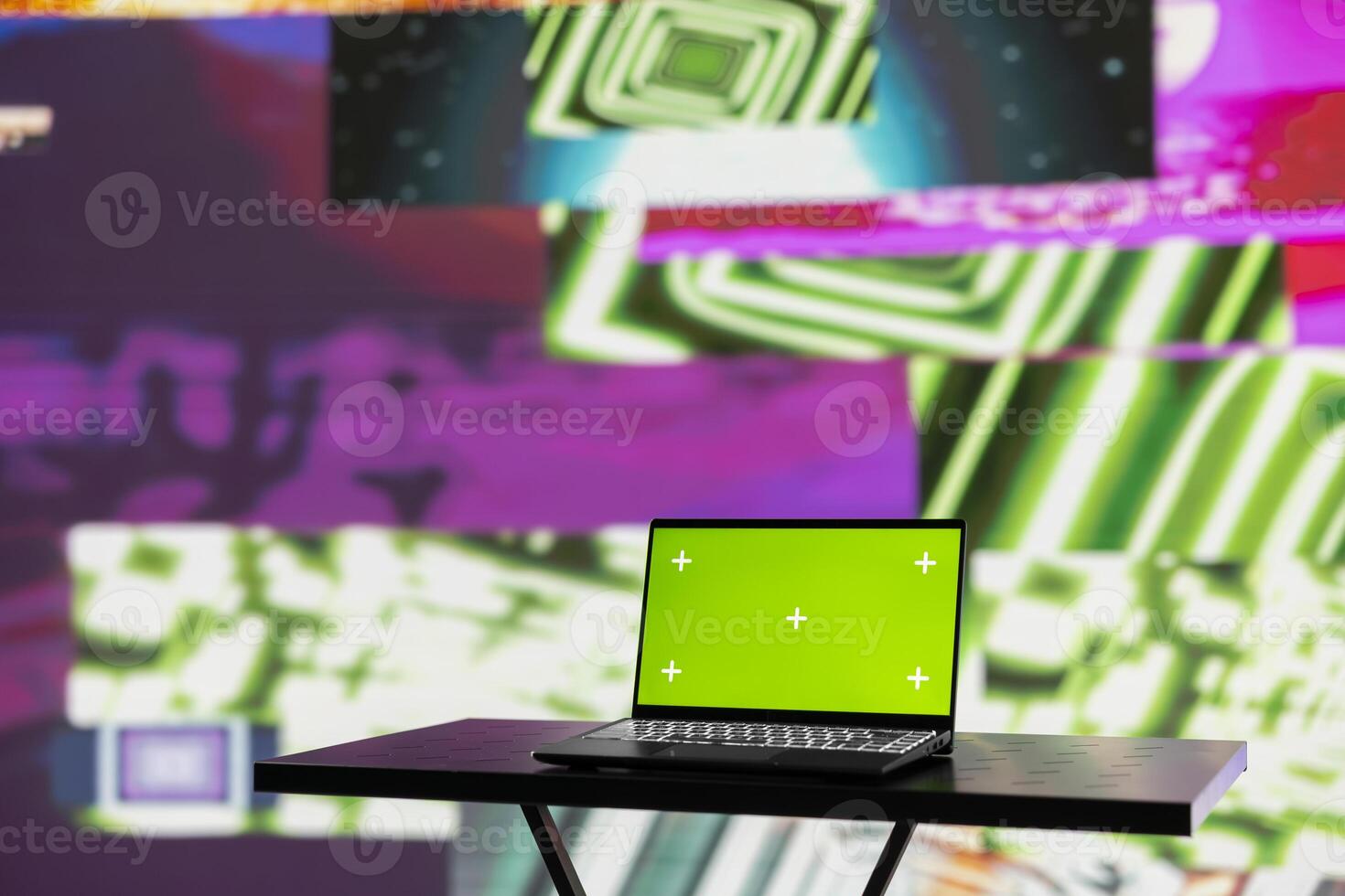 Wireless pc running chroma key display surrounded by colorful visual art clips, glowing in the dark and showcasing a clubbing atmosphere. Nightlife ambiance with urban lights and vibes. photo