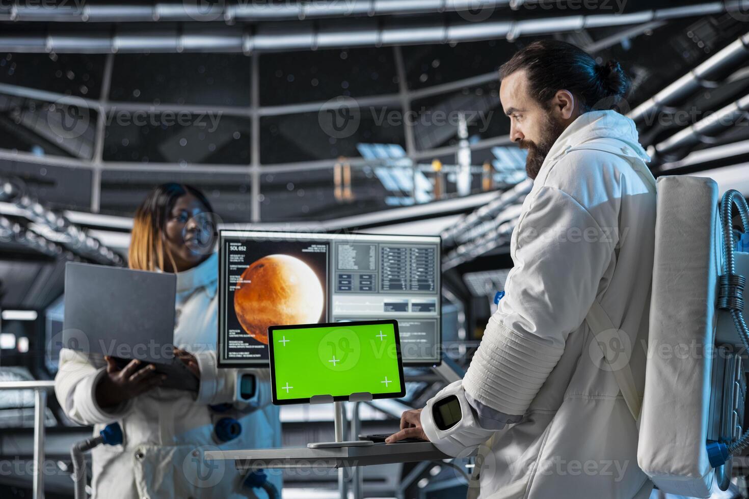 Space station researchers analyzing Mars planetary data using isolated screen tablet. Team of scientists in futuristic spaceship doing Martian surface research using mockup device photo