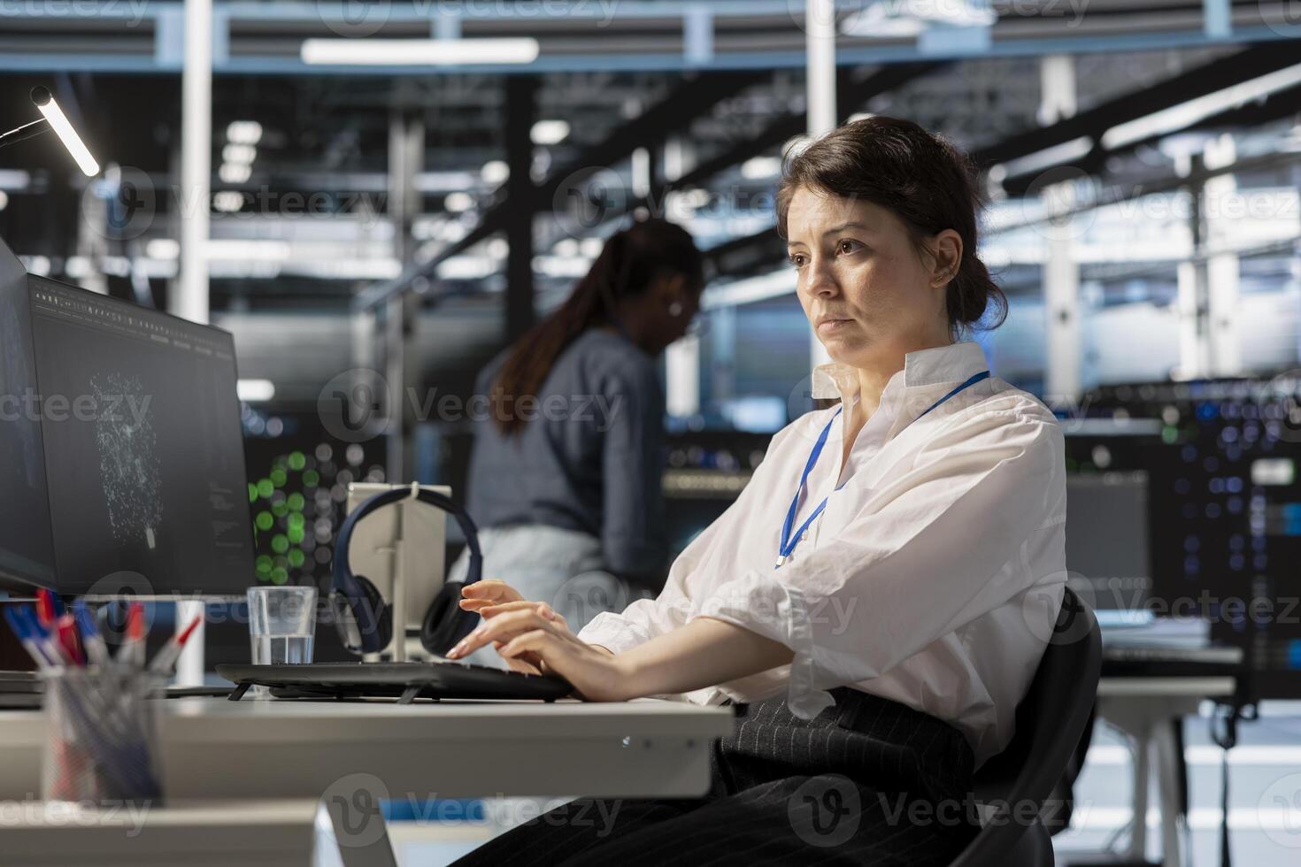 Data center computer scientist uses PC to update servers tech, configuring gear using software. Server hub IT professional reviewing hardware analytics, ensuring reliable network operations photo