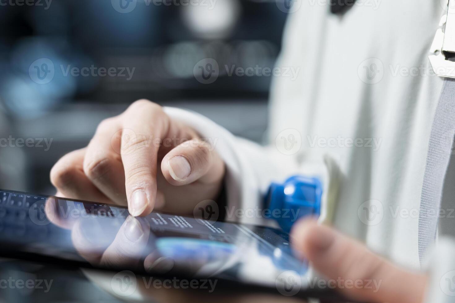 Close up of astronaut reviewing spacecraft metrics on tablet to ensure safe operation during long distance space travel. Orbital station crew member monitors system stability during cosmic journey photo