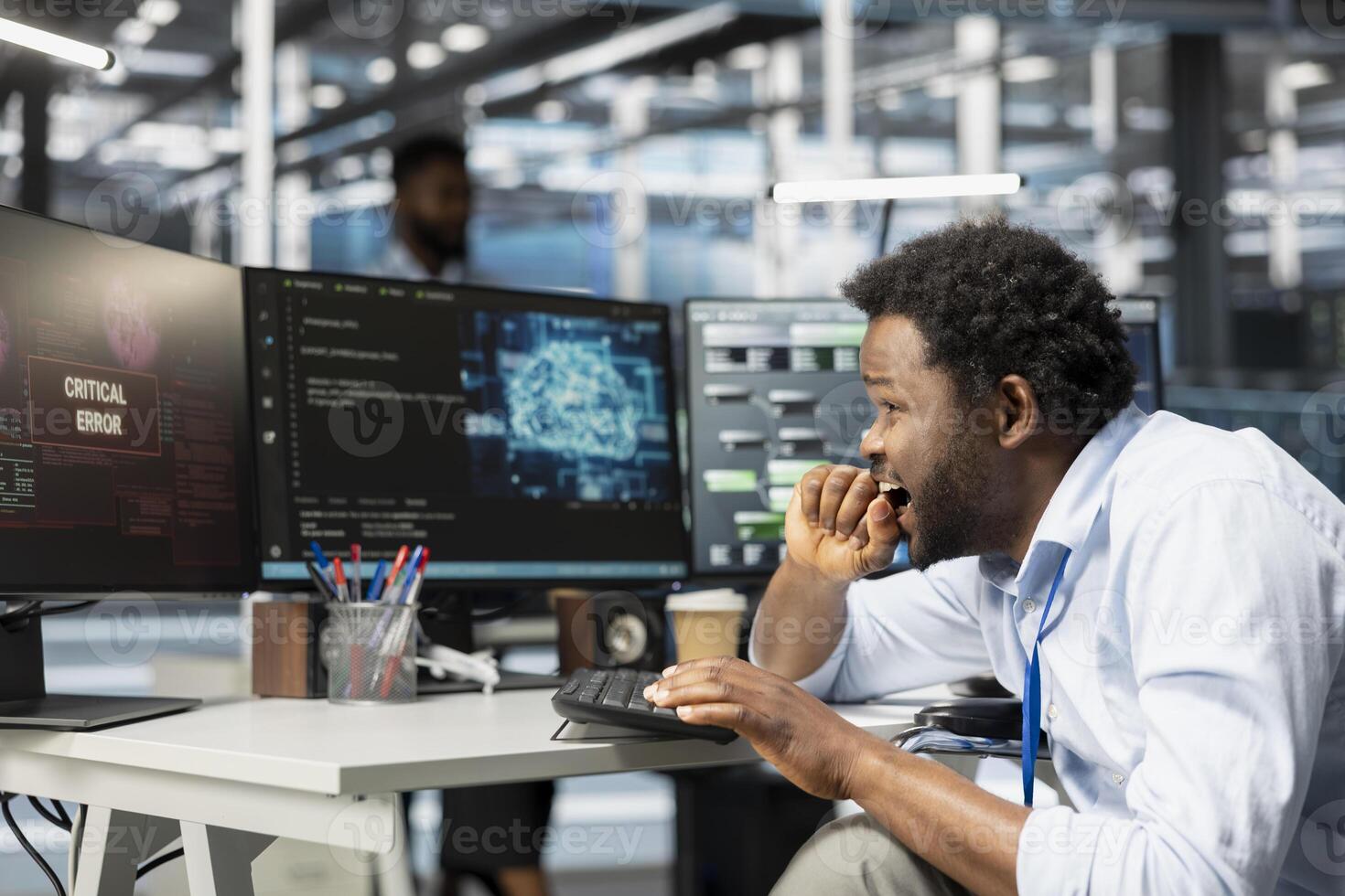 Data center system administrator panics after seeing glitch warning while using artificial intelligence model. African american man in server hub worried by errors affecting programming AI algorithms photo