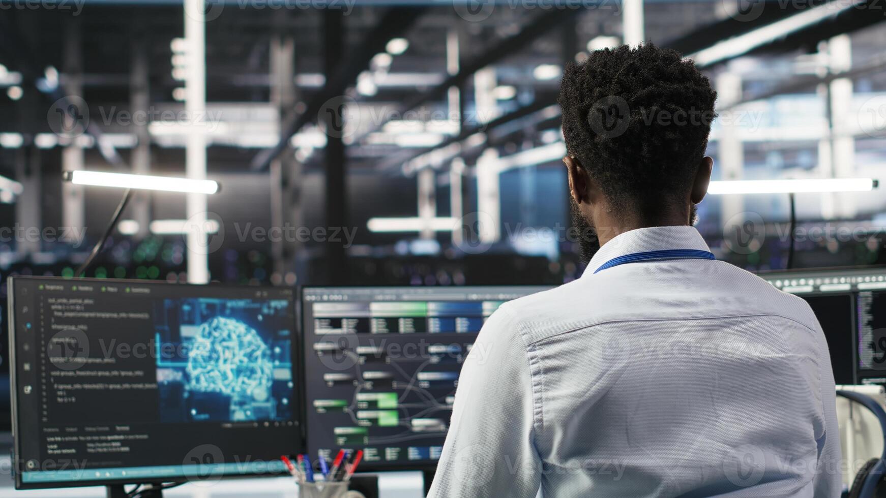 Server hub programmer using AI machine learning node tree software to optimize system health. Data center IT expert analyzing equipment issues using artificial intelligence visualization, camera B photo