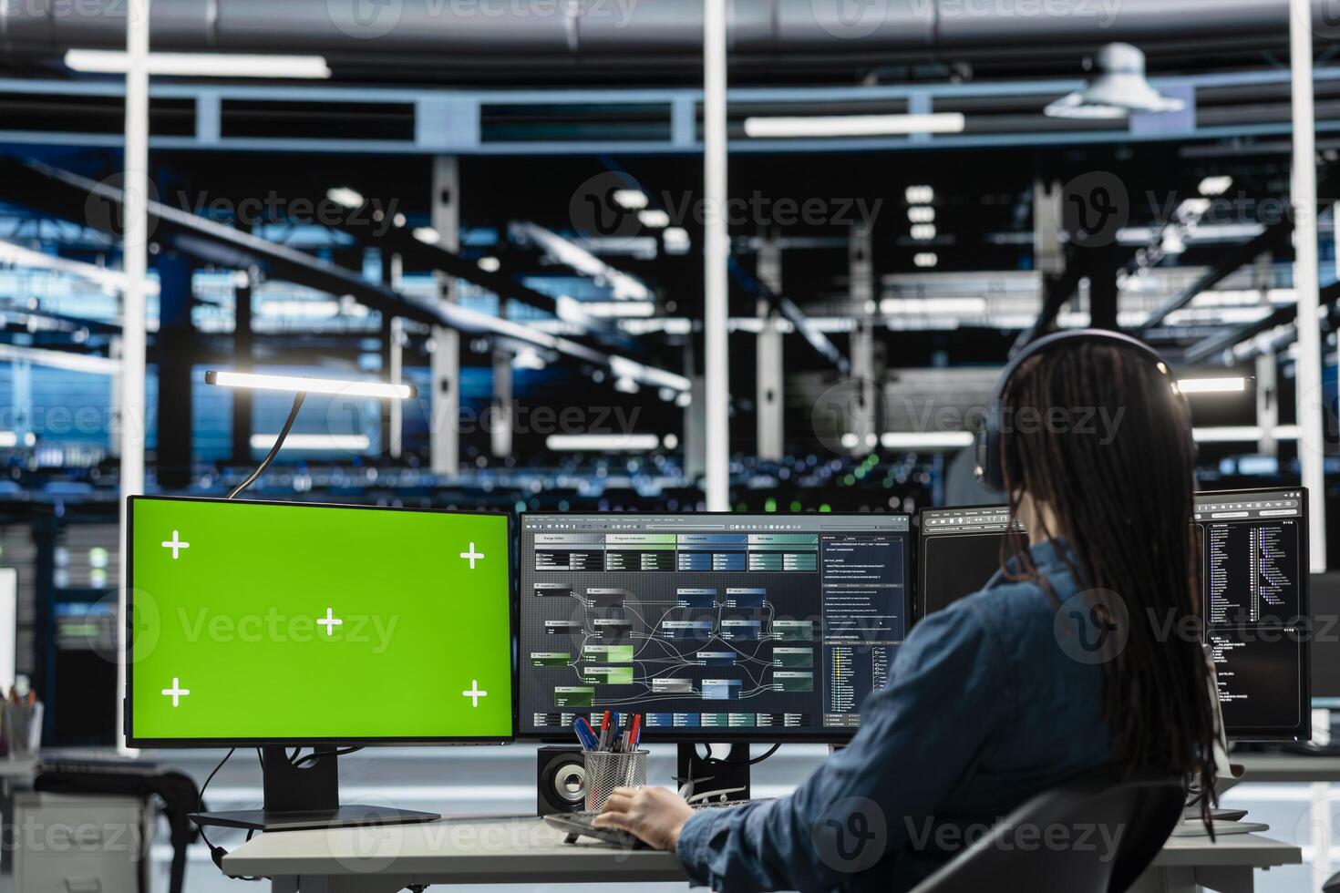 Programmer in data center using isolated screen computer to check equipment performance upgrading infrastructure. IT expert doing maintenance on supercomputers in servers room using chroma key PC photo
