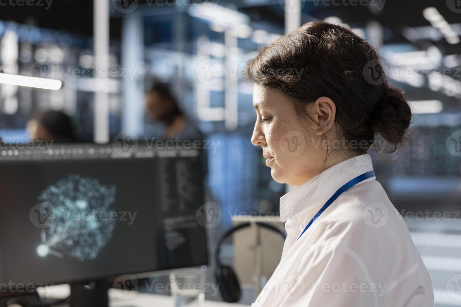 Data center computer scientist analyzing software logs metrics on PC monitor, optimizing systems. Close up of woman in server farm inspecting resource utilization, managing application efficiency photo